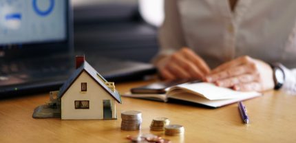 A closeup shot of a person thinking of buying or selling a house