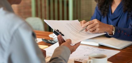 Businessman consulting with lawyer before signing contract