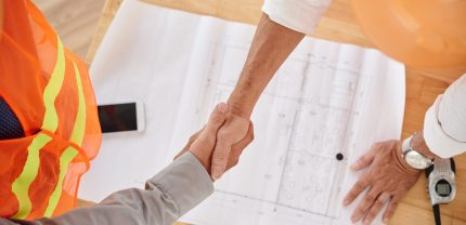 Firm handshake of contractor and head engineer