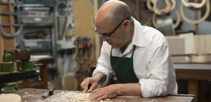 middle-aged-man-making-instruments-his-workshop-alone