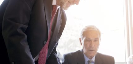 two-senior-businessman-discussing-document-office